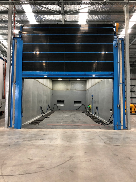Burwell rubber roll-up door on an industrial blast room, push button operated