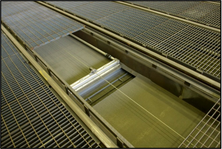 Burwell sweeper blade recovery floor with operator grating over the recessed abrasive trough